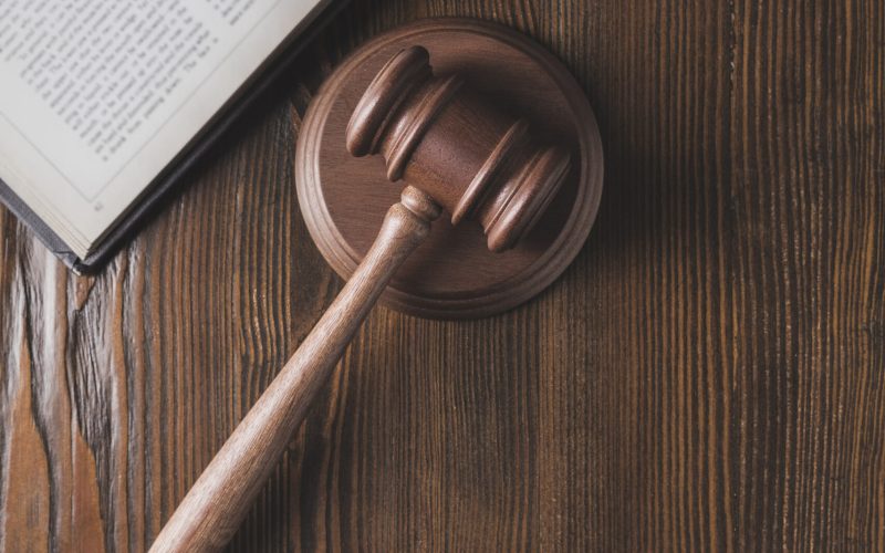 opened juridical book with hammer on wooden table, law concept opened juridical book with hammer on wooden table, law concept
